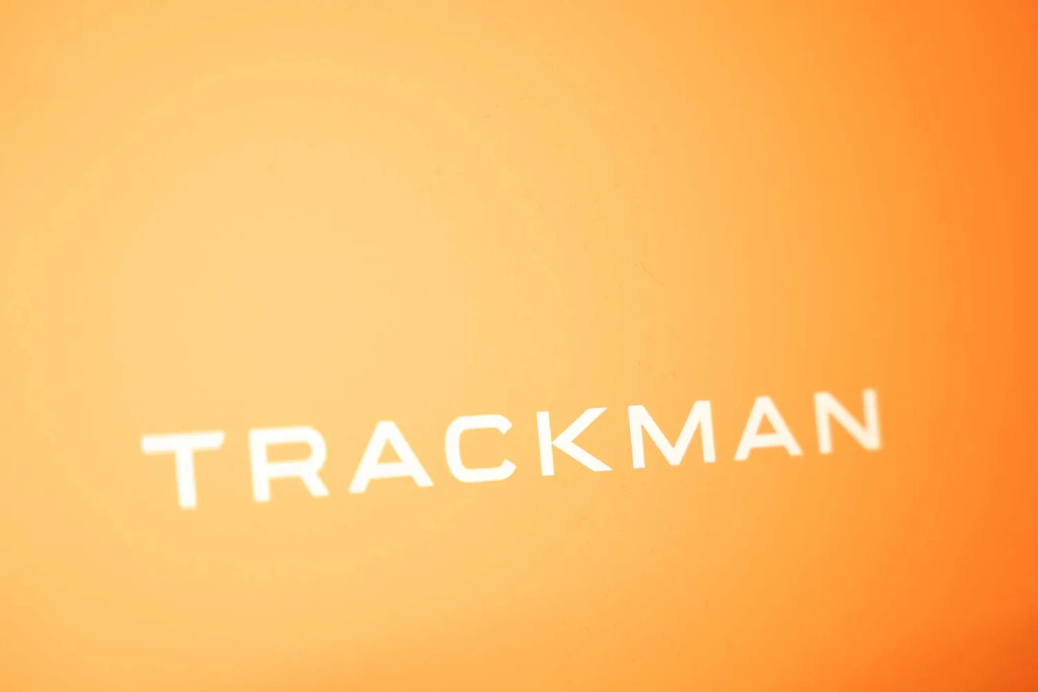 A Trackman 4 launch monitor in a Grip Golf bay